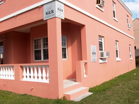 two storey pink building showing the store front