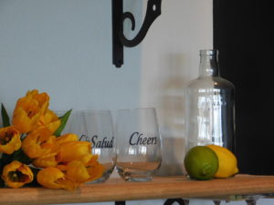 yellow roses, lemon and lime and glasses with the words cheers in two different languages