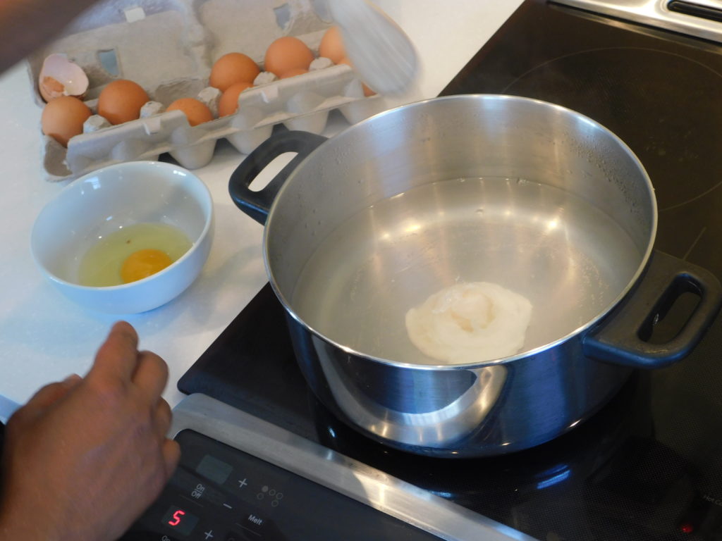 a poton a stove top poaching eggs one at a time