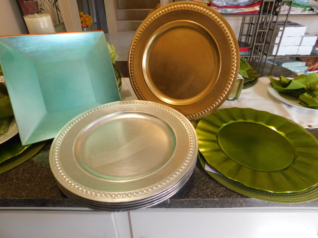 four different colour and style charger plates