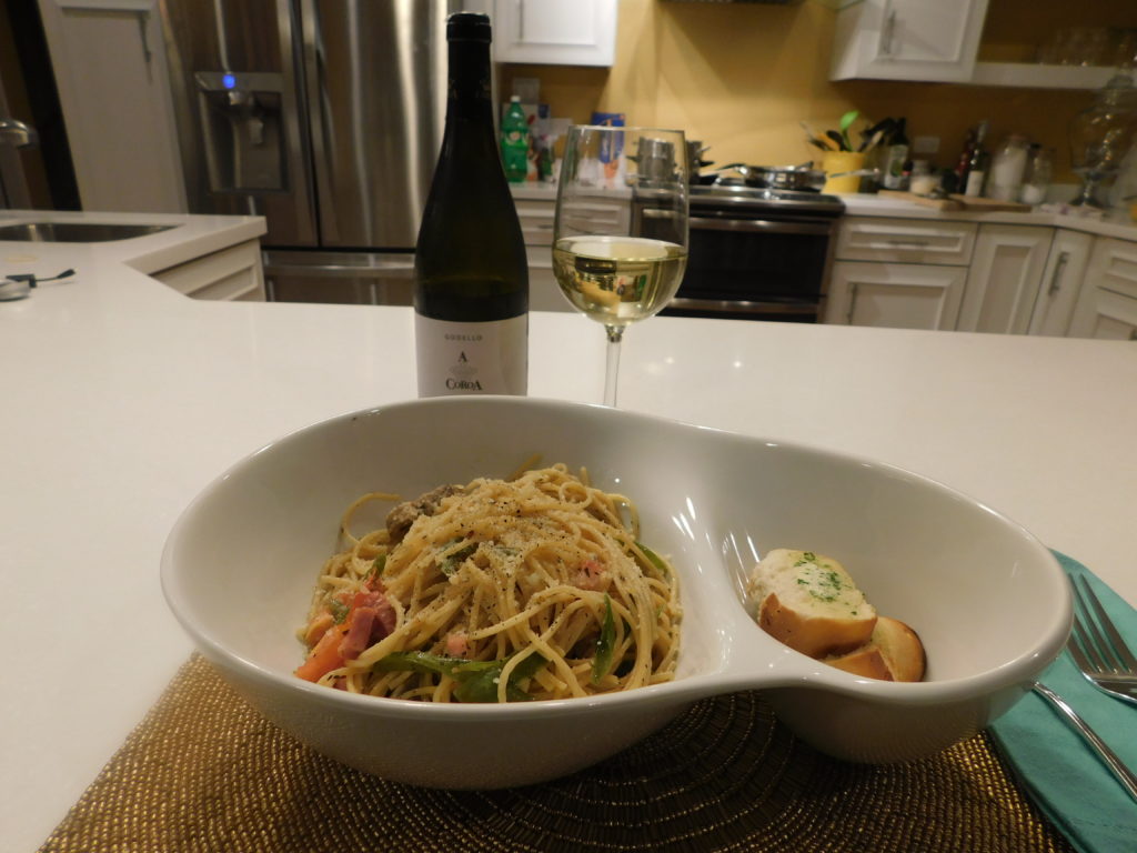 plated spaghetti dish and bottle of Godello wine