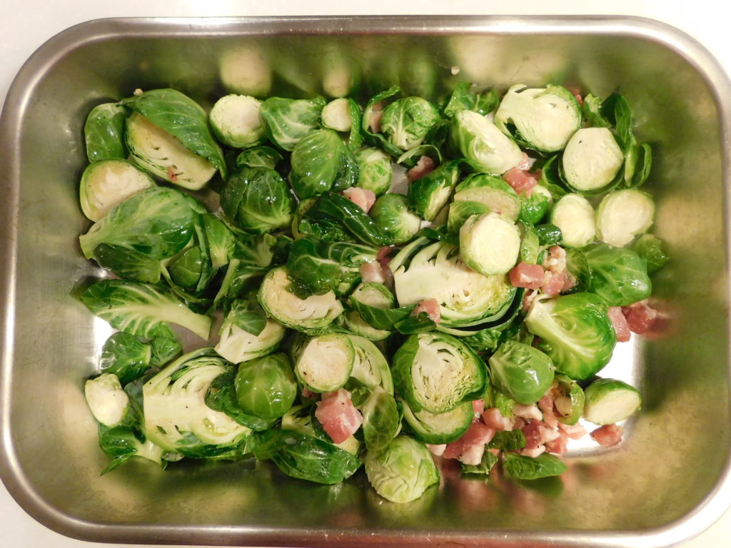 Brussels sprouts and pancetta in a pan to be roasted