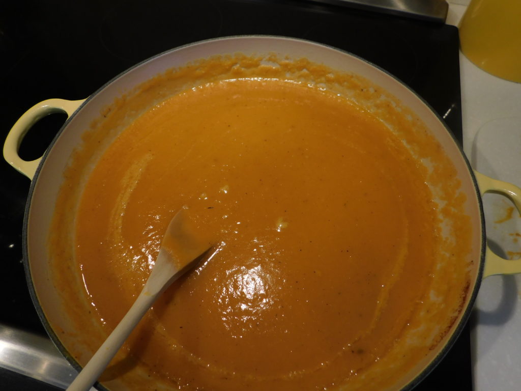 squash and chicken stock in a dutch oven simmering