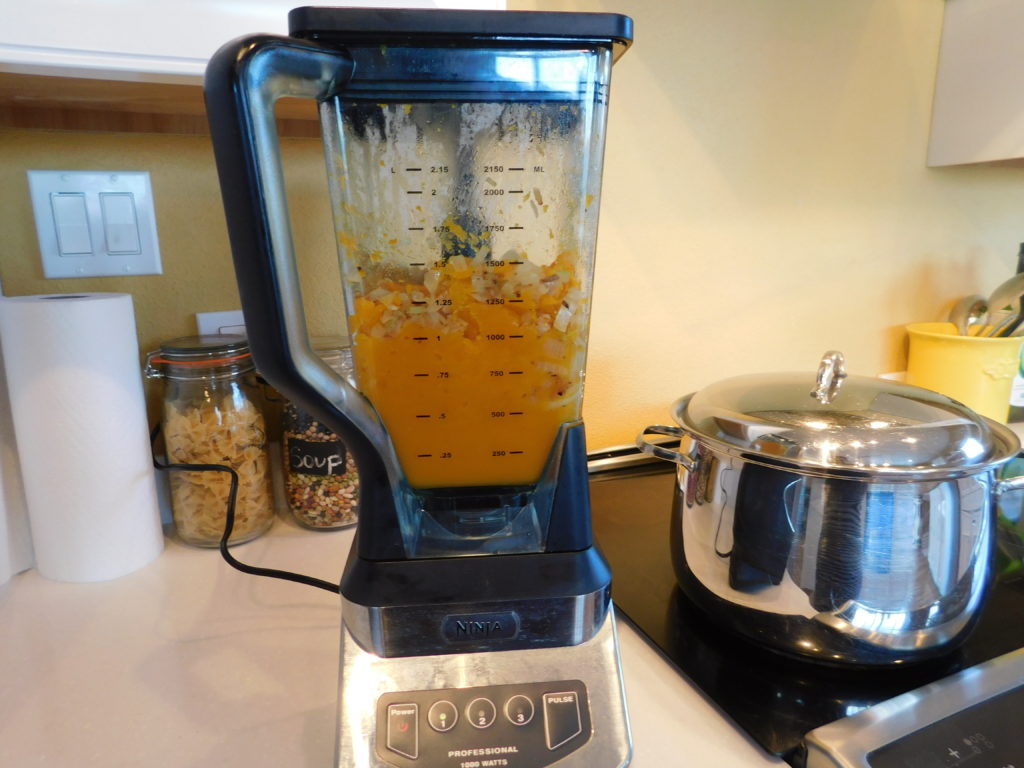 Blender containing roasted squash, sauteed onions, celery and minced garlic