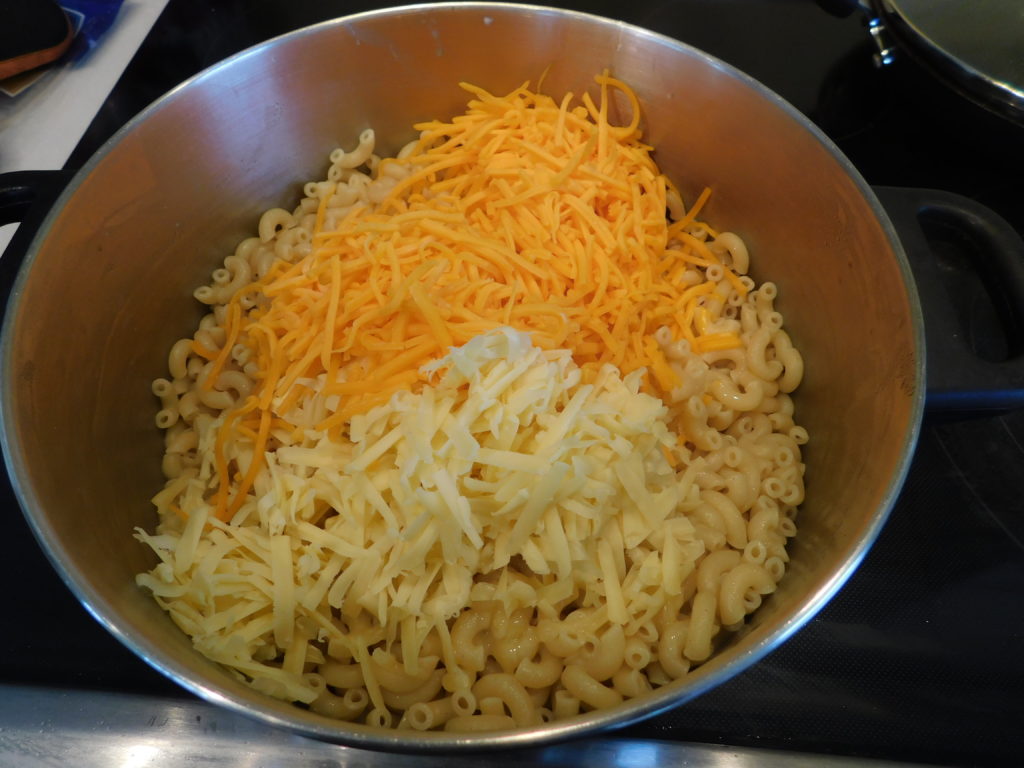 pot with macaroni and shredded cheese