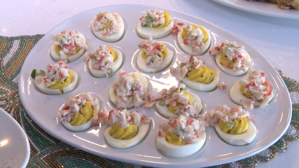 Deviled eggs on a patter topped with crab salad