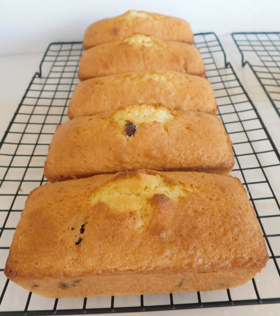 five mini loaves cooling on a cooling rack.